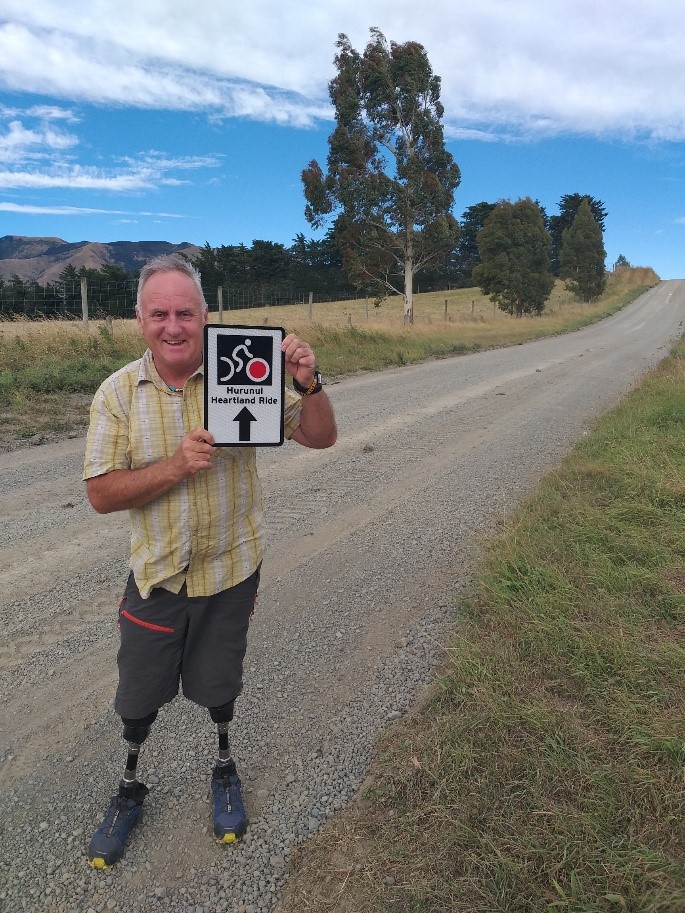 Photo: Mark Inglis with a Hurunui Heartland Ride official sign from NZTA